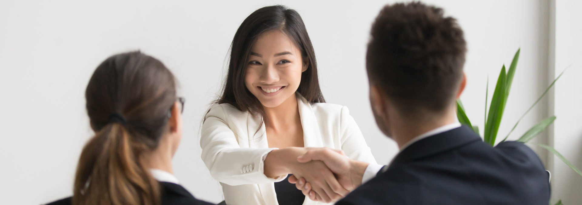 Smiling female candidate shaking hand