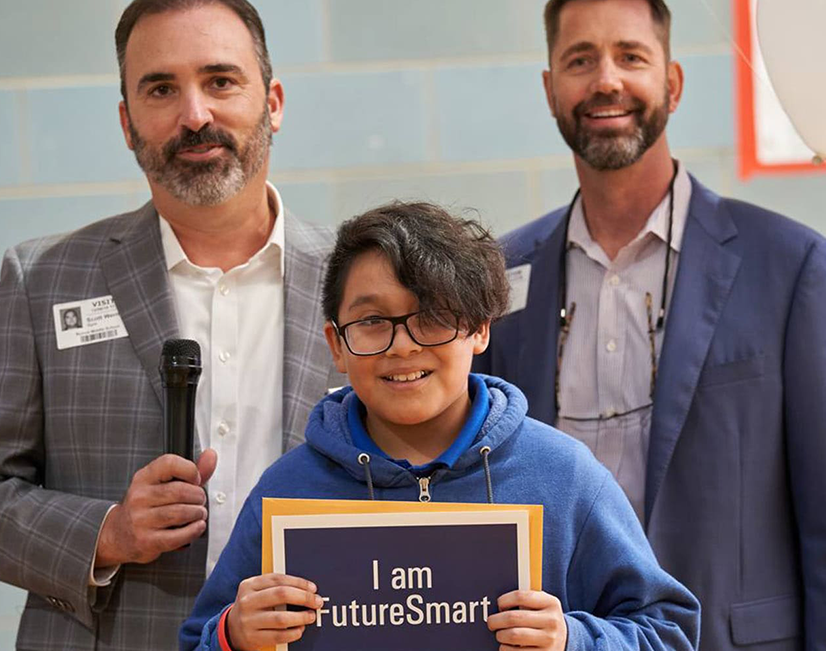 A boy holding up a sign that says "I am FutureSmart".