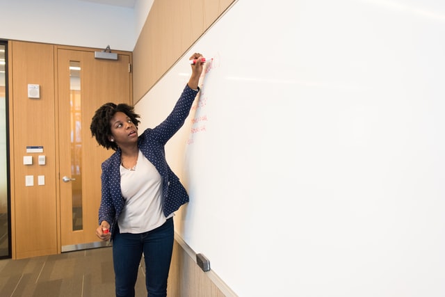 Black woman at whiteboard