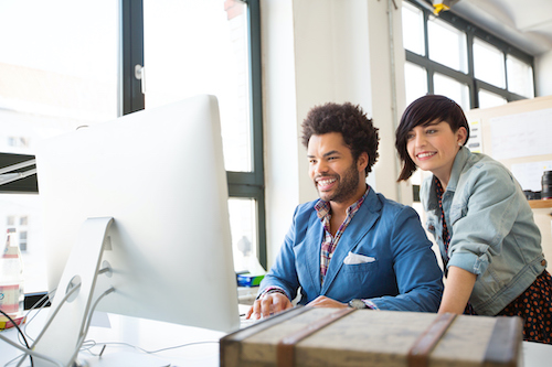 Young man and woman working together on new business projects at office. Businesspeople working on a computer.
