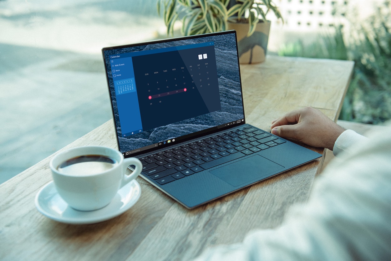 Laptop on desk with coffee mug
