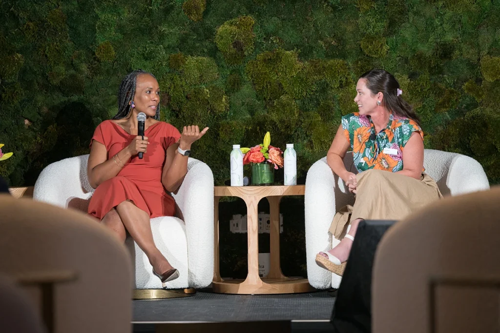Two women discuss on stage during the summit