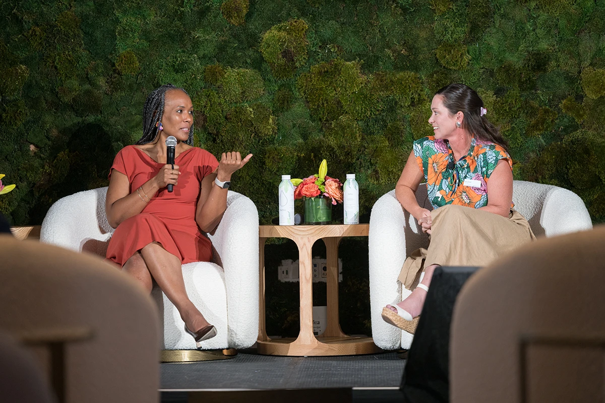Two women discuss on stage during the summit