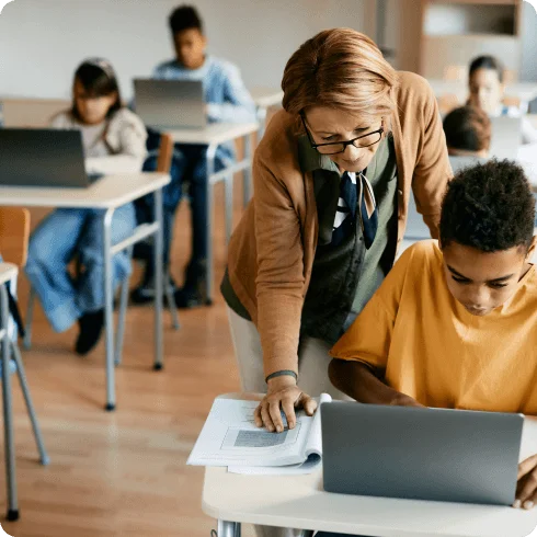 Teacher working with student during class