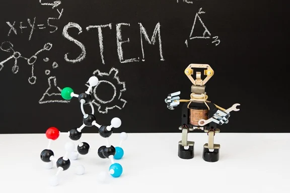 STEM lesson concept with chalkboard drawings, molecule models, and a robot figure.
