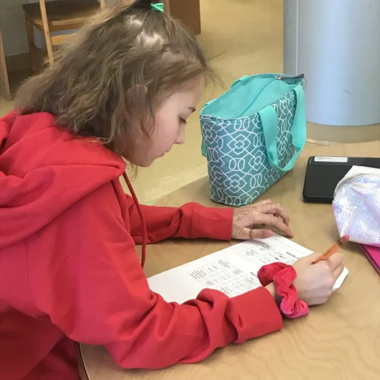 Young student looks at her work