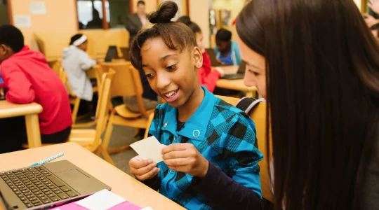 Teacher working with middle school student