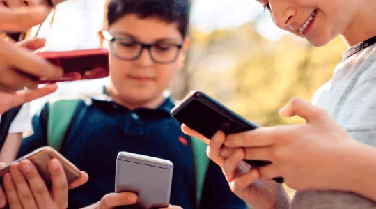 Children gathered using smartphones