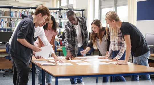 High school students working together in library