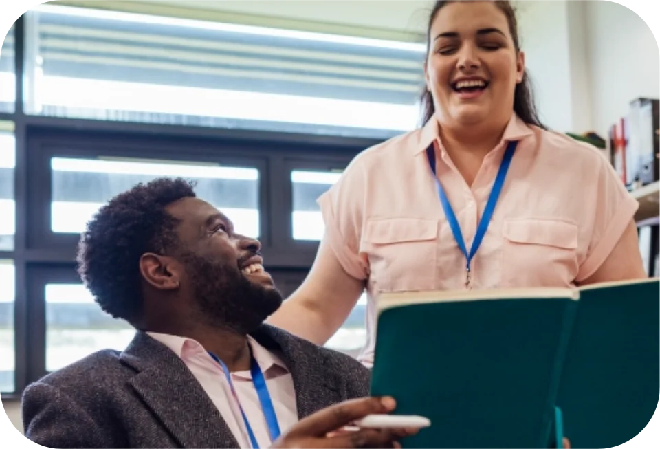 Two colleagues talking at desk