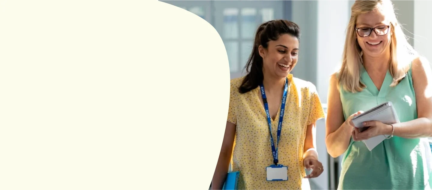 Two colleagues talking in corridor