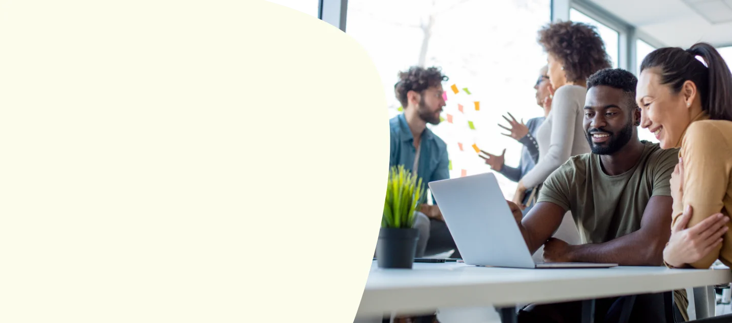 Colleagues gathered around laptop