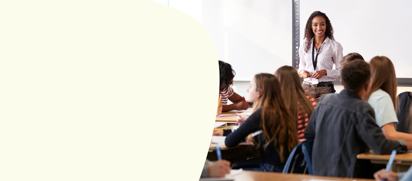 Teacher smiling in front of class