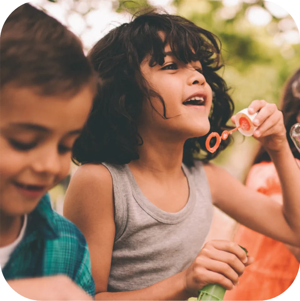 Young children blowing bubbles