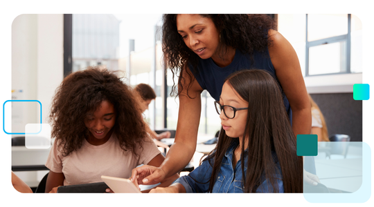 A teacher assists two diverse middle school students using tablets in a classroom.