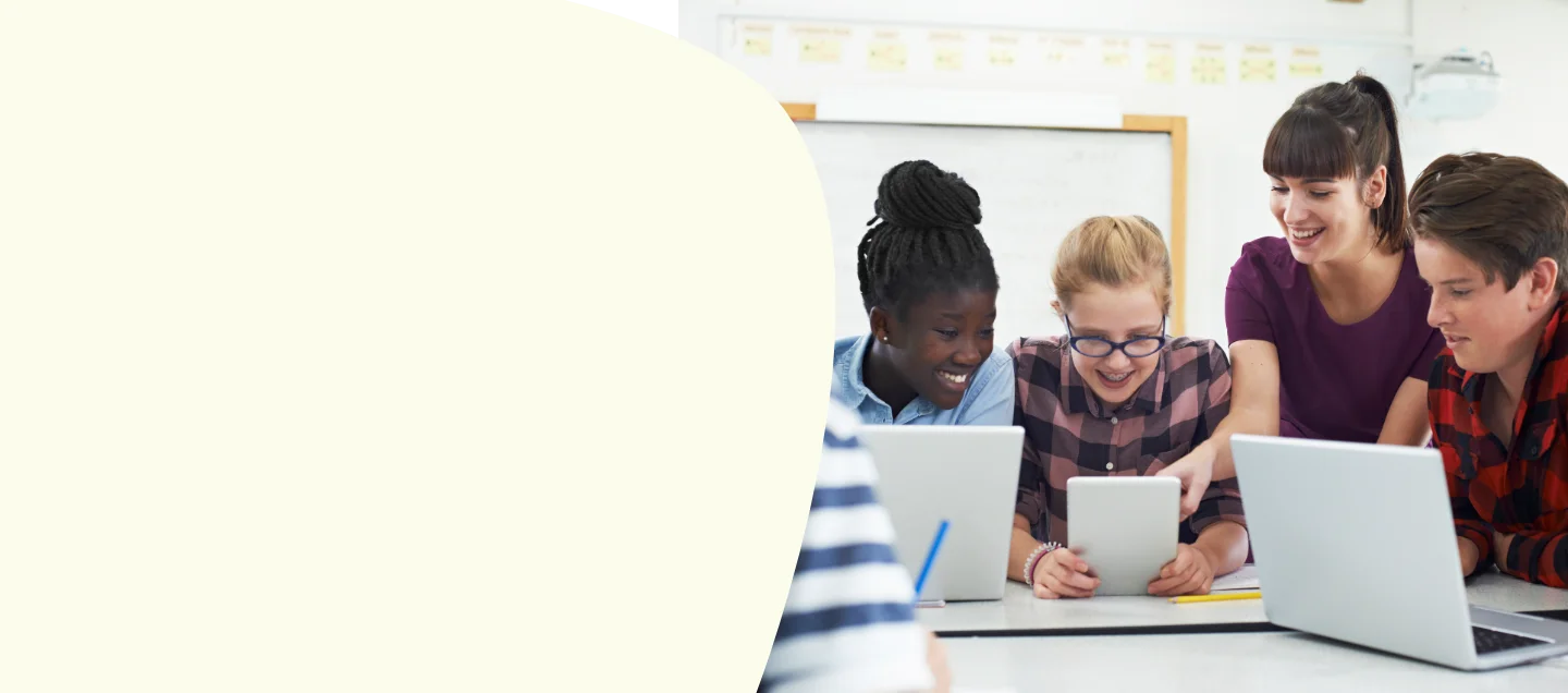 Older students gathered around laptop