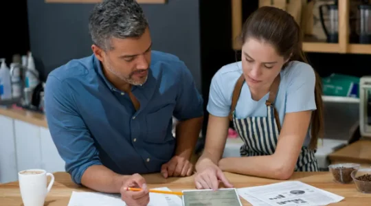 Boss and employee reviewing marketing materials