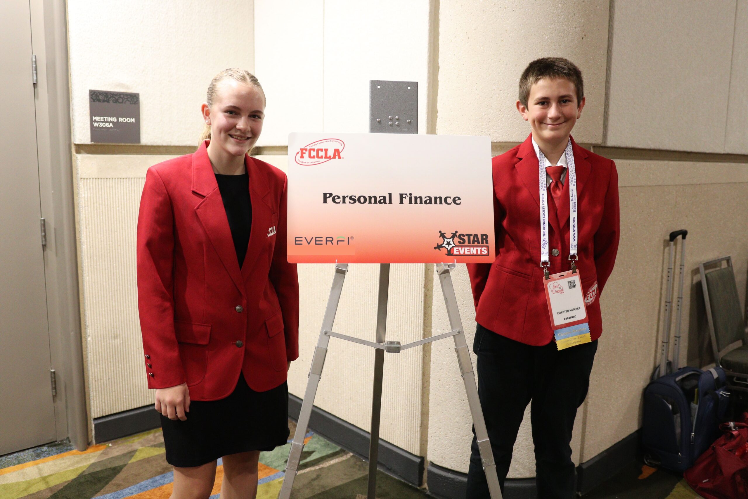Two FCCLA students standing in front of the STAR Event poster