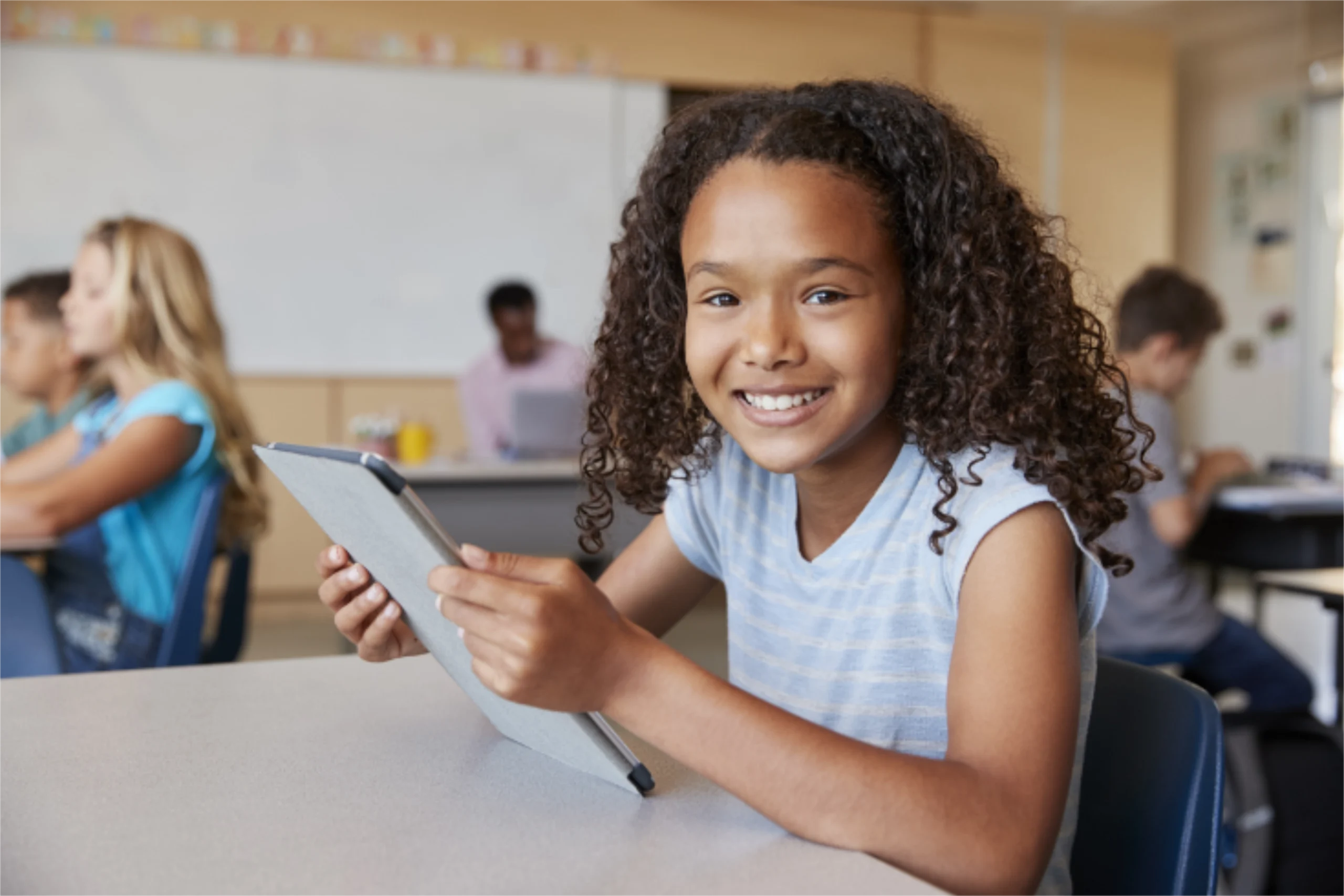 Elementary school student smiling with tablet